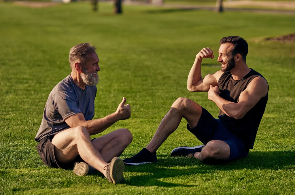 happy-father-son-sitting-grass-talking